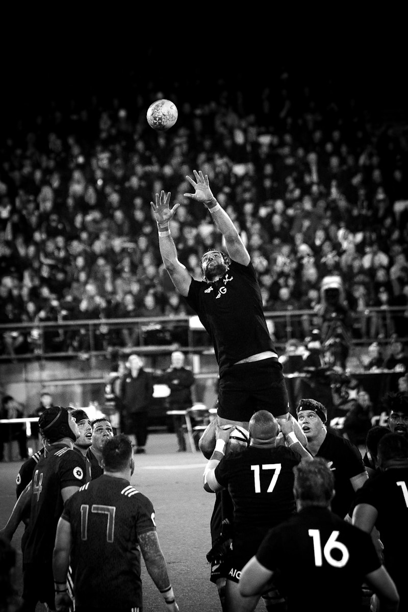 grayscale photo of NFL player catching ball